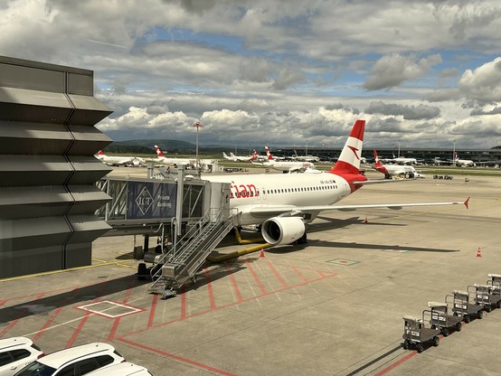 A photo from an Austrian airplane standing at a gate waiting to depart to Vienna.